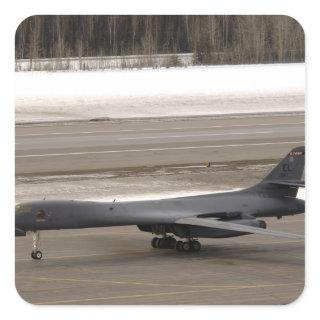 A B-1B Lancer performs a touch and go Square Sticker