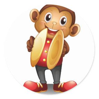A monkey holding cymbals classic round sticker