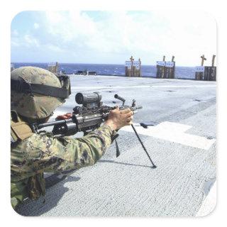 A US Marine adjusting his weapon Square Sticker