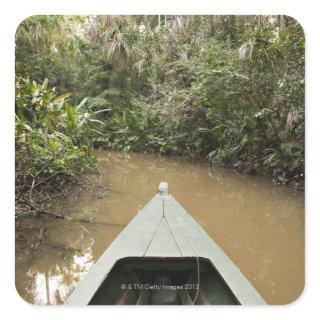 A wooden canoe made of Eucylptus tree floats in 2 Square Sticker