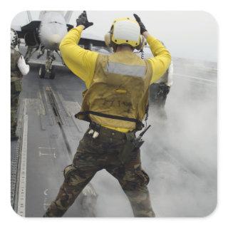 An aircraft director signals a F/A-18C Hornet Square Sticker