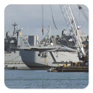 An F-15 Eagle gets a lift from a barge crane Square Sticker