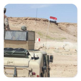 An instructor watches as an Iraqi army soldier Square Sticker
