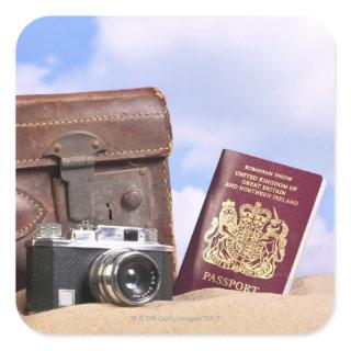 An old leather suitcase, retro camera and square sticker