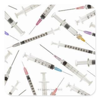 Assortment of syringes in various sizes and square sticker