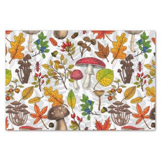 Autumn mushrooms, leaves, nuts and berries on whit tissue paper