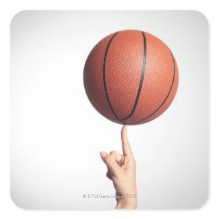 Basketball on index finger,hands close-up square sticker