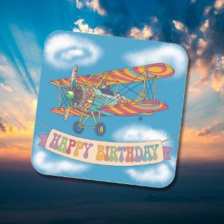 Biplane flying over happy birthday banner square sticker