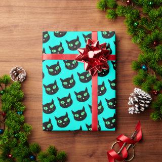 Black cat with green eyes on turquoise blue