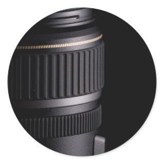 Close up of modern camera lens on black background classic round sticker