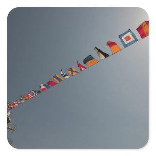 Flags fly over the deck of the USS Iwo Jima Square Sticker