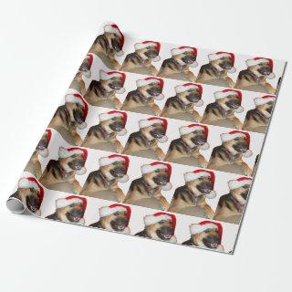 German Shepherd wearing a Santa Claus hat