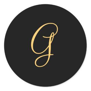 Gold-colored initial G on black monogram  round Classic Round Sticker