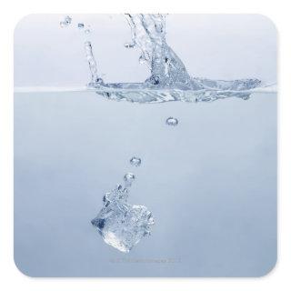 Ice cube splashing into water square sticker