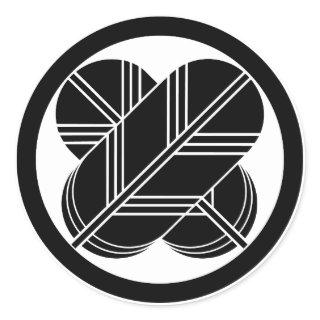 Intersecting hawk feathers with foot in circle classic round sticker