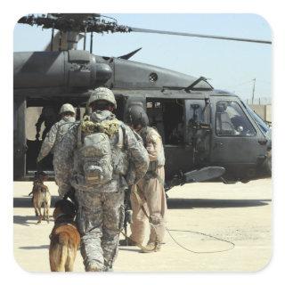 Military working dog handlers board a helicopte square sticker