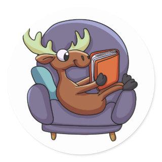 Moose reading a book on a sofa | choose back color classic round sticker