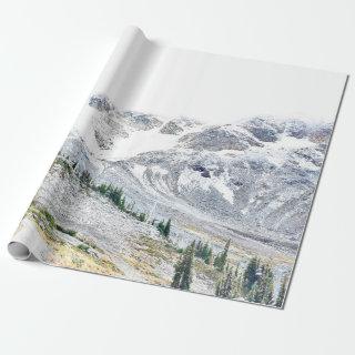 PINE TREES NEAR MOUNTAIN COVERED WITH SNOW