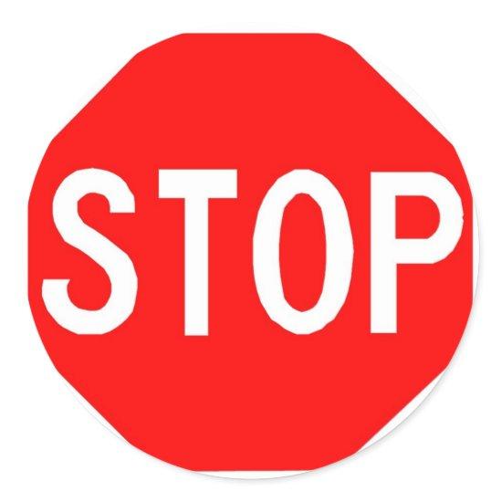 Round sticker with Stop sign.