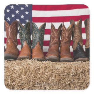 Row of cowboy boots on haystack square sticker