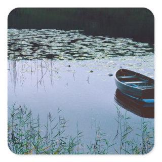 Rowboat on small lake surrounded by water square sticker