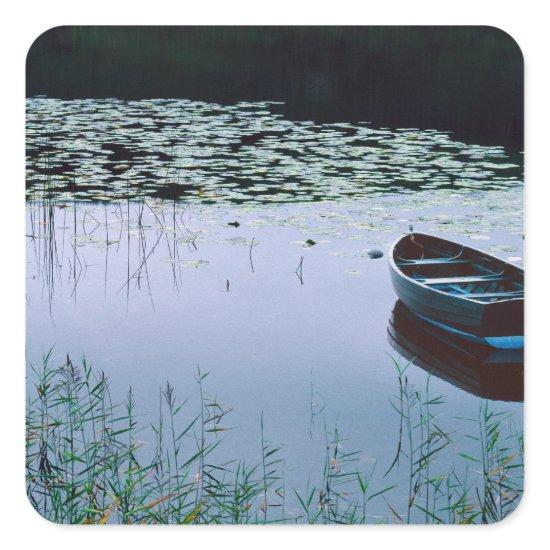 Rowboat on small lake surrounded by water square sticker