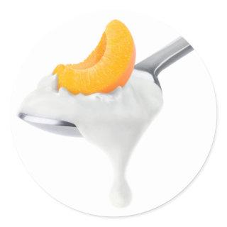 Spoon of peach or apricot yogurt classic round sticker