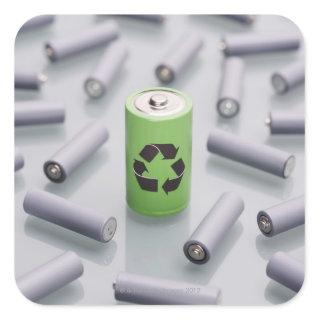 Surrounded by smaller grey batteries. square sticker