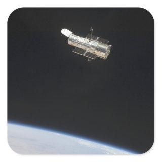 The Hubble Space Telescope in orbit above Earth 2 Square Sticker