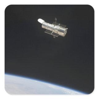 The Hubble Space Telescope in orbit above Earth 2 Square Sticker