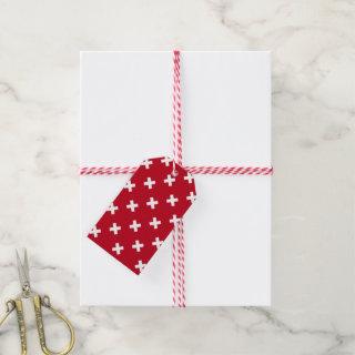 White cross stitches on red gift tags