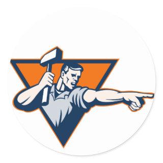 worker with hammer pointing to side classic round sticker