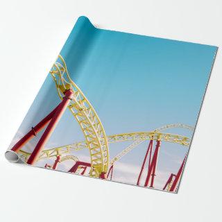 Yellow and red roller coaster under blue sky at da